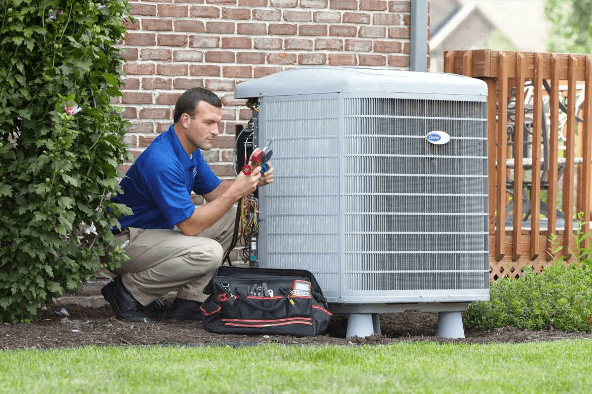 HVAC technician installing an outdoor air conditioner unit